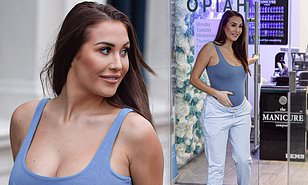 Pregnant Chloe Goodman clutches her growing baby bump during ...