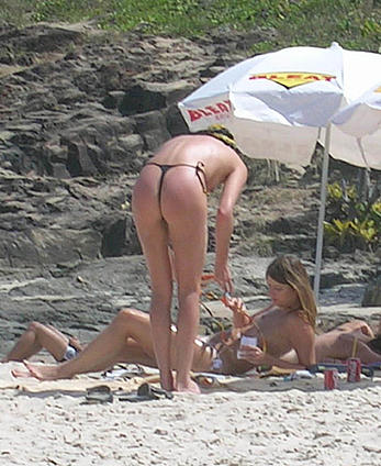 Charlize Theron topless on a beach