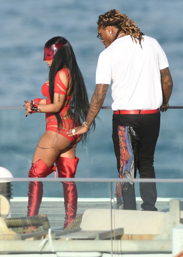 Nicki Minaj flaunts unreal curves in red cutout swimsuit as ...