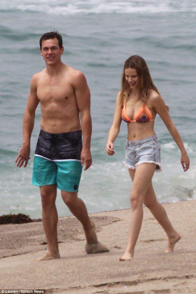Bikini-clad Halston Sage frolics on the beach with co-star ...