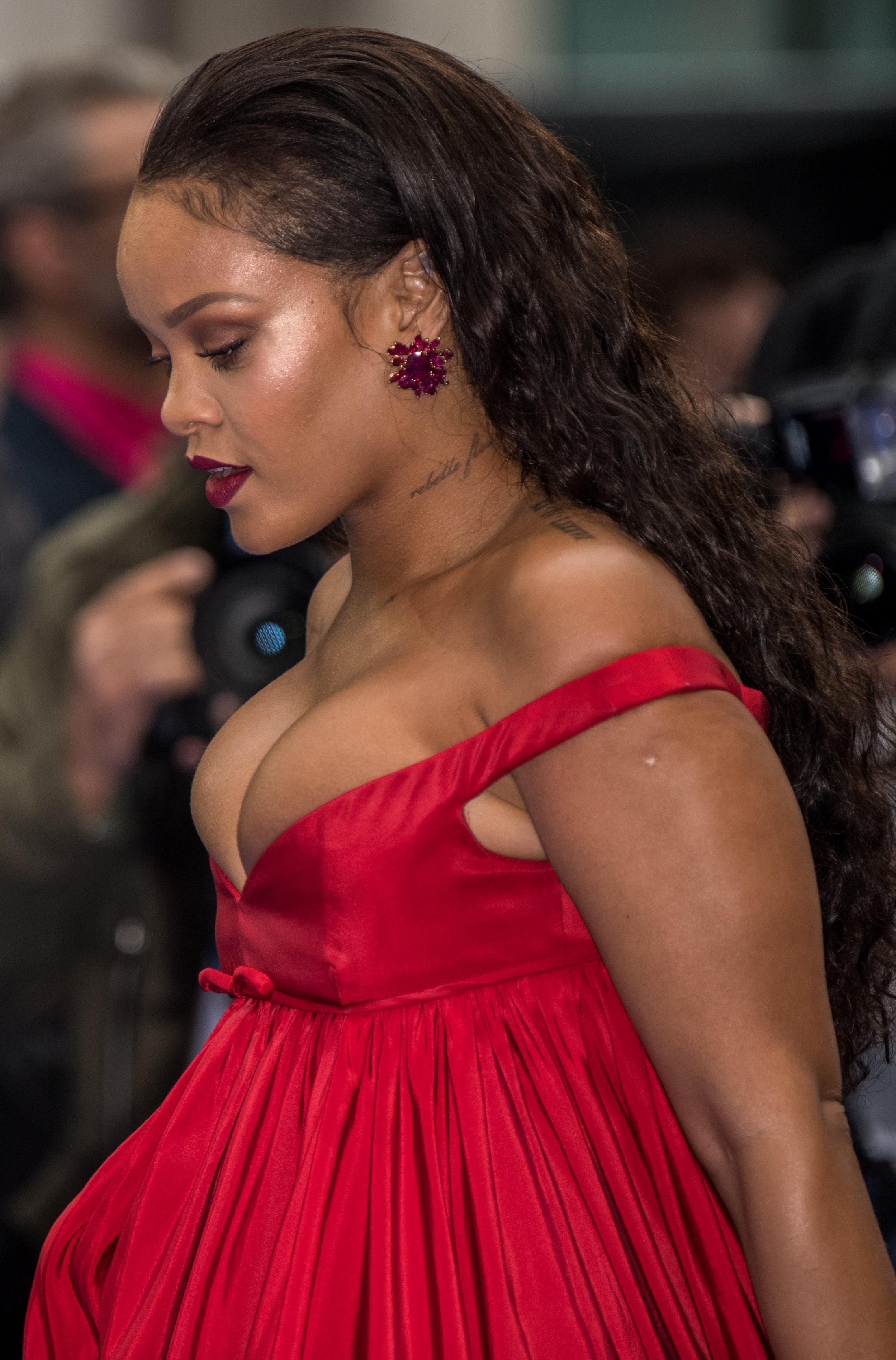 Rihanna's boobs 'vanish' as she swaps her busty red dress ...