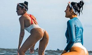 Halsey shows off her peachy derriere as she hits the surf ...