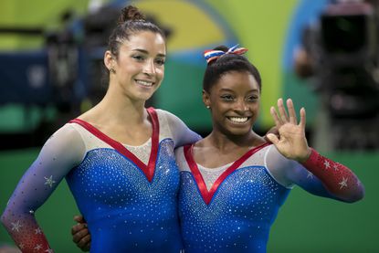 Olympic champs Simone Biles and Aly Raisman posing in SI ...