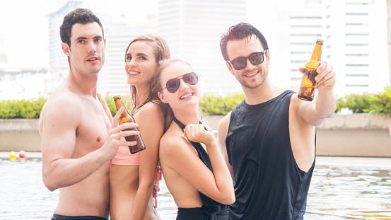 Group Of People In Swimming Bikini Nude Dance And Party In Water Pool With  Beverage Of Bottle Of Beer Stock Photo - Download Image Now
