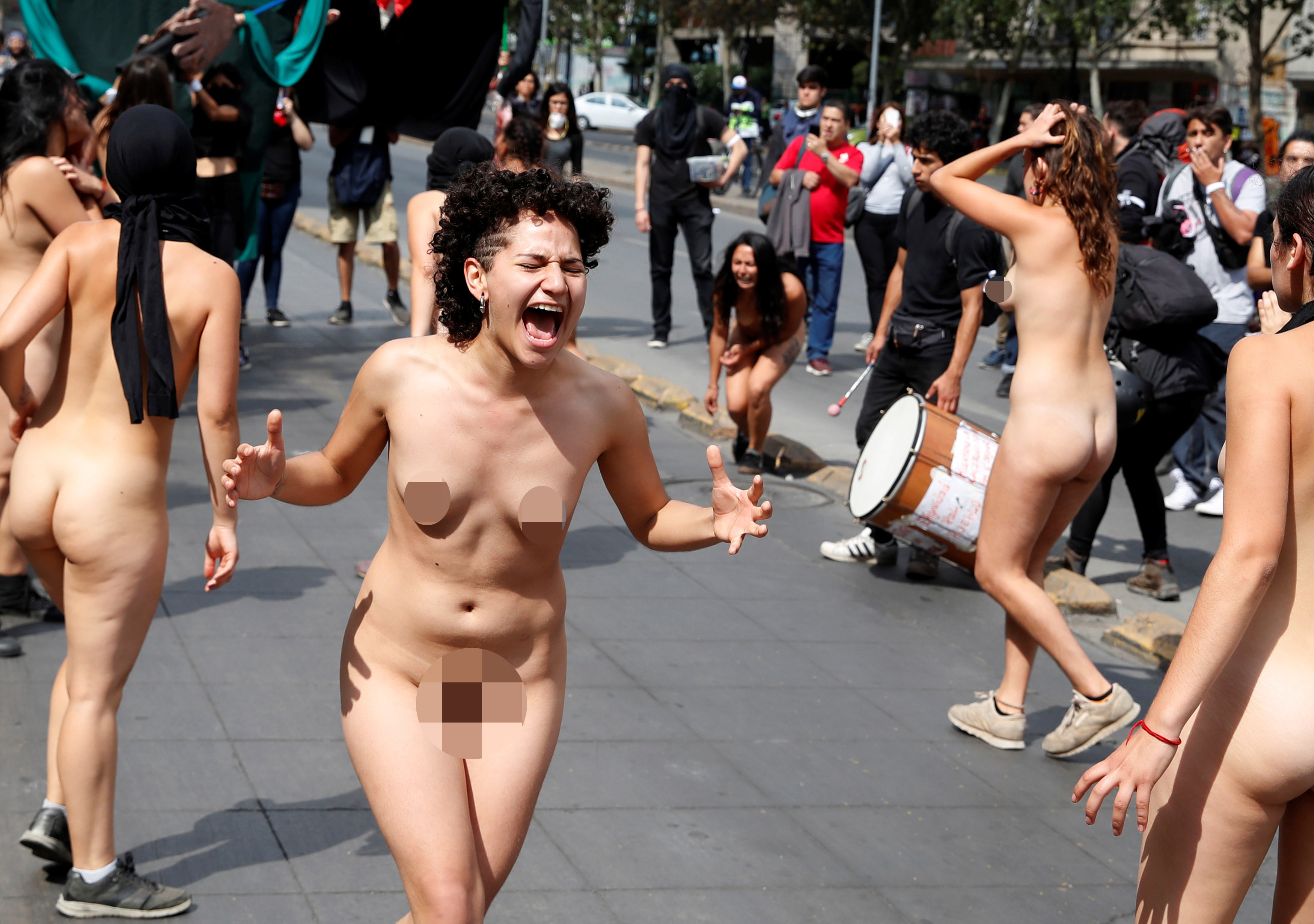 Naked women take part in a rally marking international day.