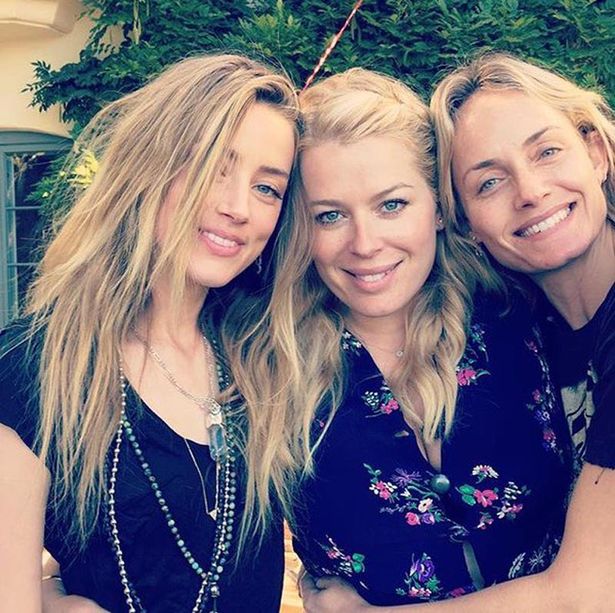 Amber Heard pictured smiling with friends just hours after ...